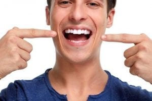 Man pointing at his healthy teeth