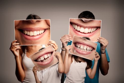 A family of four highlights their smiles after sticking to a strong dental hygiene routine.