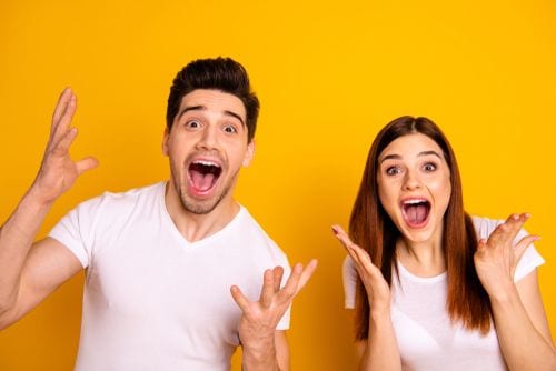 A mom and dad demonstrating the level of excitement you should exhibit about going to the dentist.