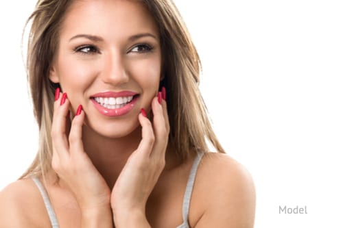 Young woman smiling with perfect white teeth