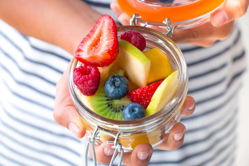 Girl holding jar of fruit