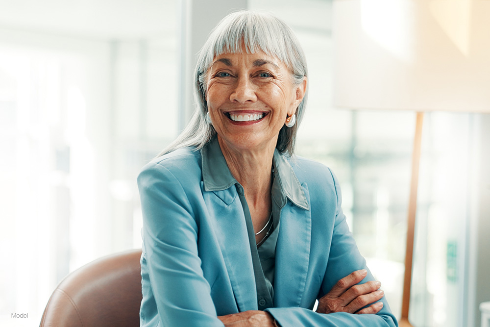 Mature woman in a blue suit smiling