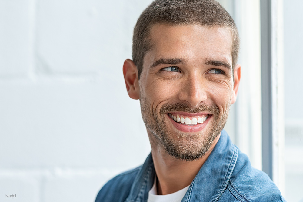 Mature man in a blue shirt smiling