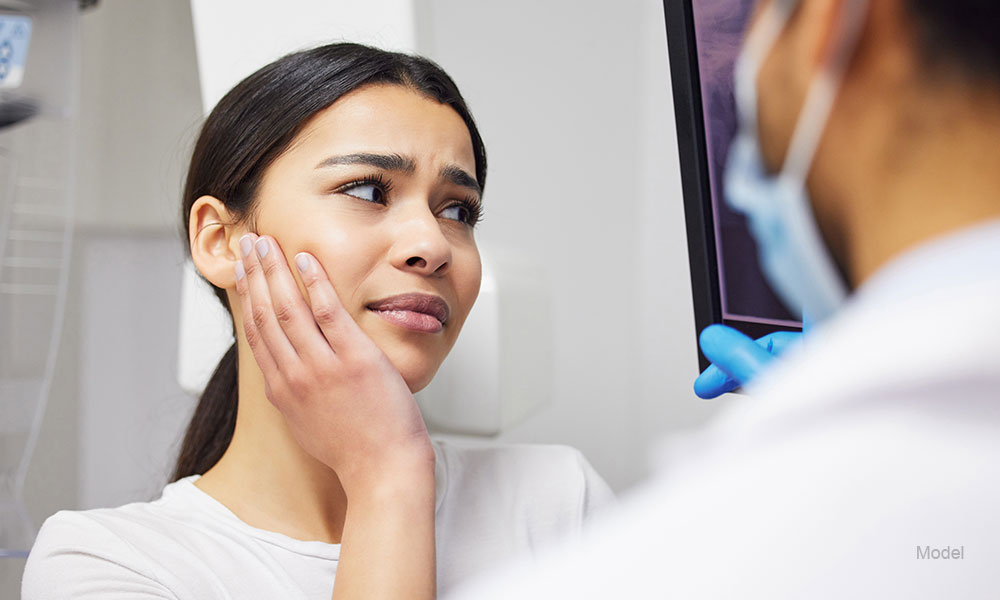 Toothache, dentist and woman in pain, clinic and consultation for dental health of patient in office. Appointment, person and listening to diagnosis of doctor, cavity and medical help for mouth