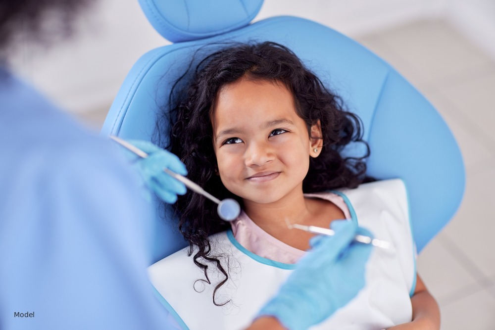 Smiling girl in dental chair during checkup